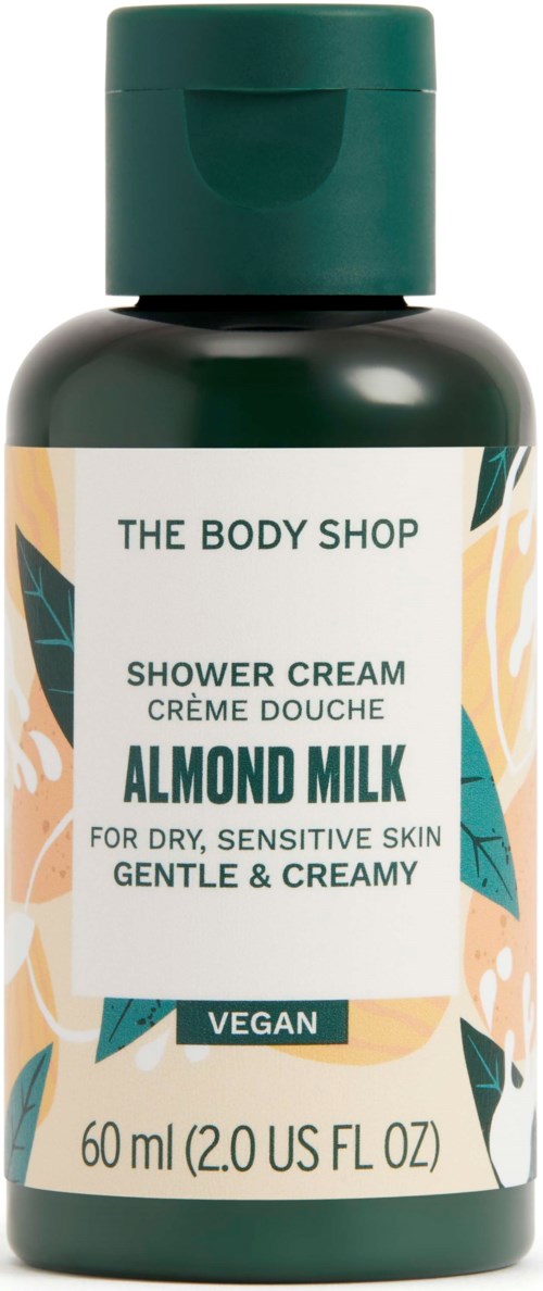 Dunkelgrüne Flasche Duschschaum von The Body Shop mit Mandelmilch für empfindliche Haut, vegan, 60 ml.