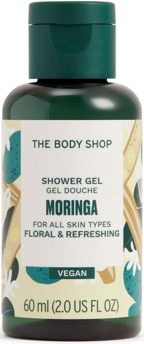 A green bottle of The Body Shop shower gel with Moringa, vegan, for all skin types, floral and refreshing scent.
