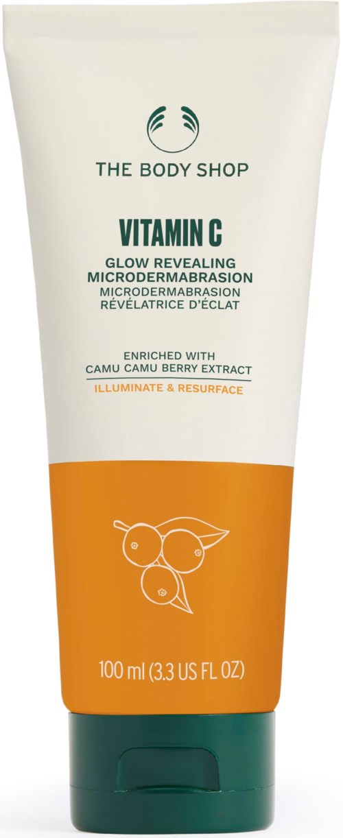 Eine Tube von The Body Shop Vitamin C Hautpflege mit orange- und grünem Design, erwähnt Hautglanz und Mikrodermabrasion.