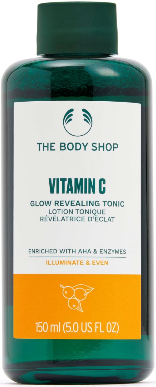 A green bottle of The Body Shop Vitamin C glow revealing toner with white and orange label.