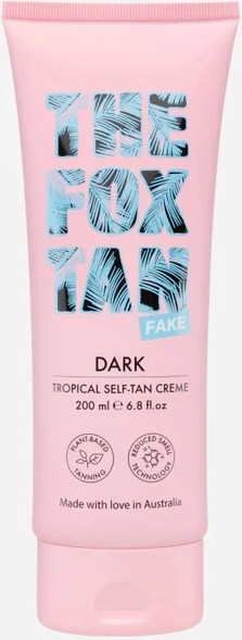 Pink tube of self-tanning cream with blue text saying "The Fox Lane Fake Dark" for skin tanning. Made in Australia.