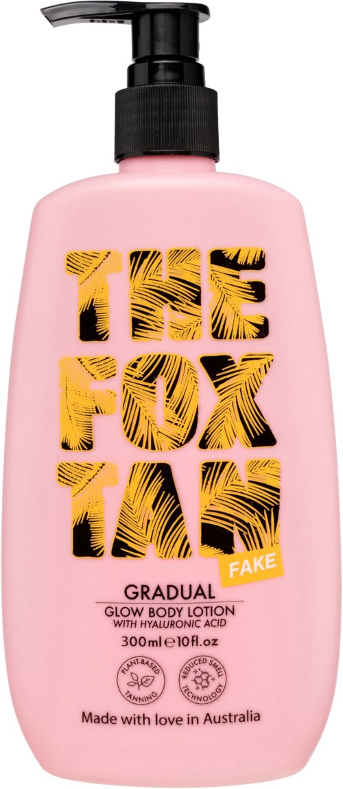 A pink bottle with a black pump labeled 'The Fox in Gradual' glow body lotion with a floral design.