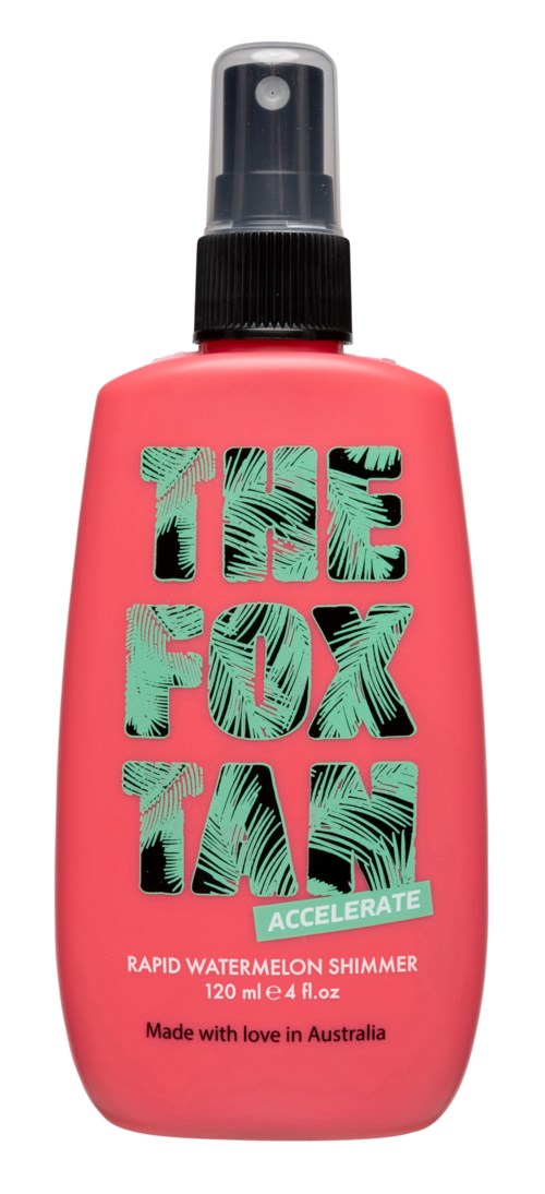 A pink spray bottle labeled "THE FOX TAIL ACCELERATE" with a black spray nozzle, containing watermelon shimmer spray.