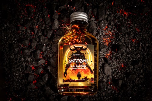 A small bottle with a dragon illustration, glowing orange, placed on black, fiery, rocky ground.