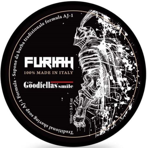 The image shows a black circular label with white and red text, featuring a sketch of a knight in armor.