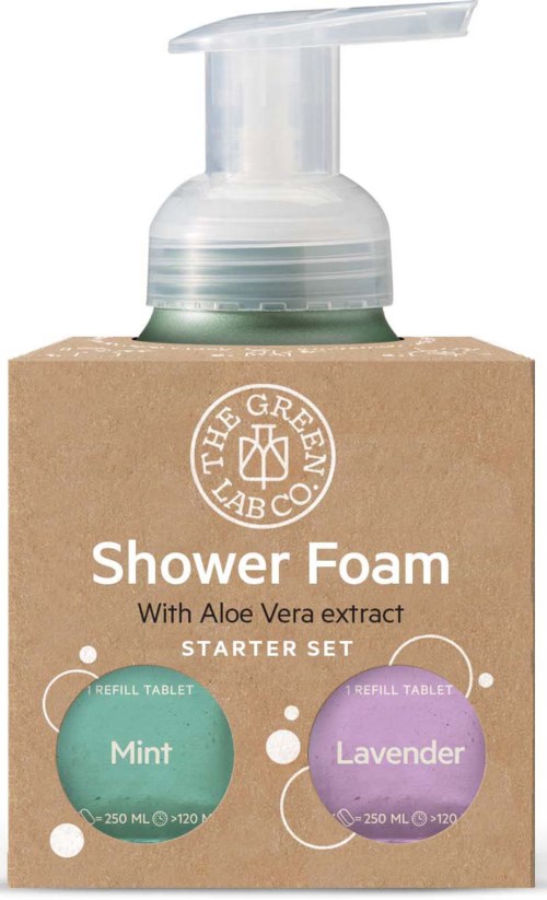 A shower foam bottle with pump, on a brown cardboard box, labels for mint and lavender scents, contains aloe vera.