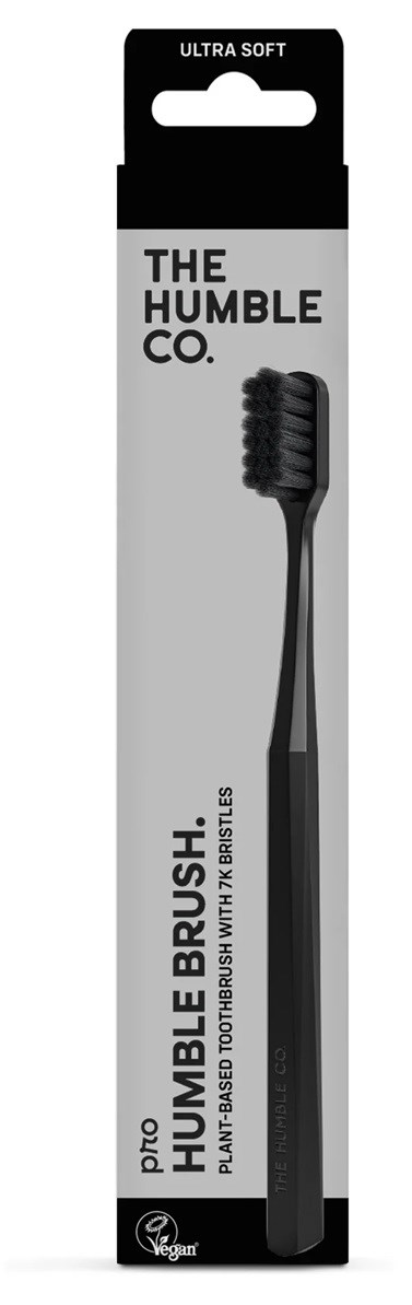 A black toothbrush with a gray handle, packaged in a white and black box labeled 'Ultra Soft' and 'The Humble Co.'