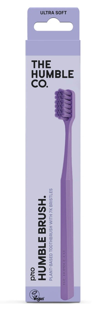 Purple toothbrush with soft bristles in purple packaging, labeled as "Ultra Soft" and "Humble Co.".