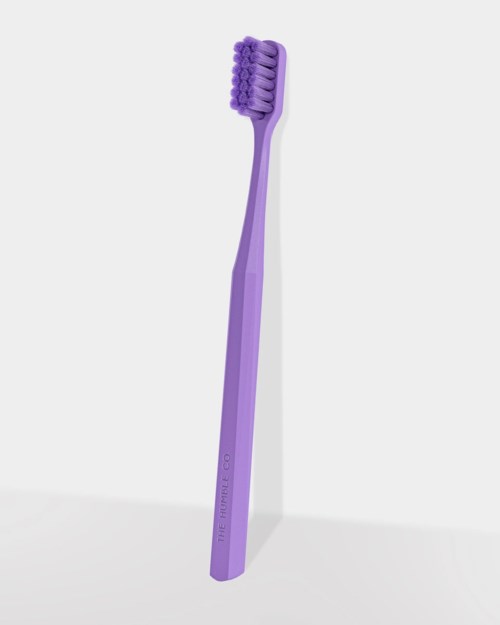 A purple toothbrush with soft bristles and a sleek handle.