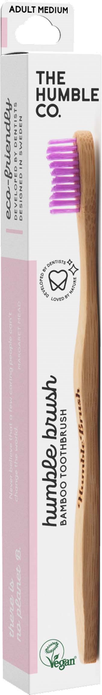 Eine Bambuszahnbürste in Weiß und Braun mit rosa Borsten, gekennzeichnet 'The Humble Co.' und 'Adult Medium.'