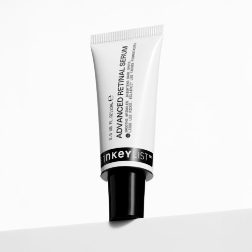 A tube of skincare product titled 'Advanced Retinal Serum' with black and white design, standing on a flat surface.