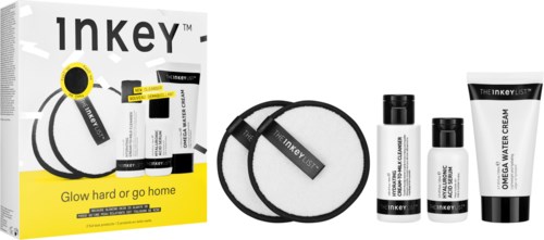 Skincare set includes three bottles, a cream, and a headband, with packaging that says "Glow hard or go home."