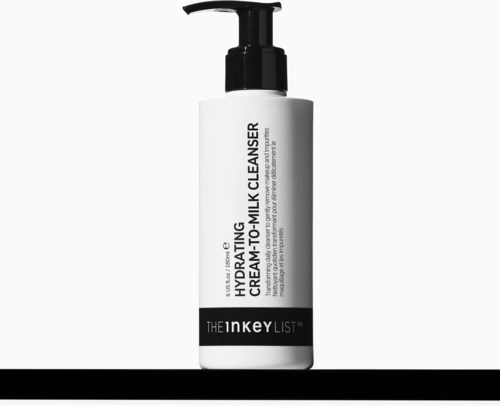 A white bottle with a black pump labeled hydrating cream-to-milk cleanser, from The Inkey List.