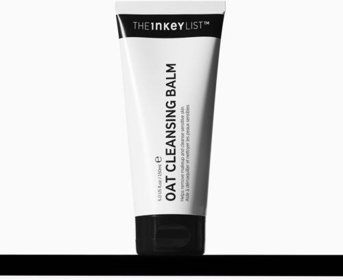 Een witte en zwarte tube met de tekst The Inkey List Oat Cleansing Balm voor huidreiniging.