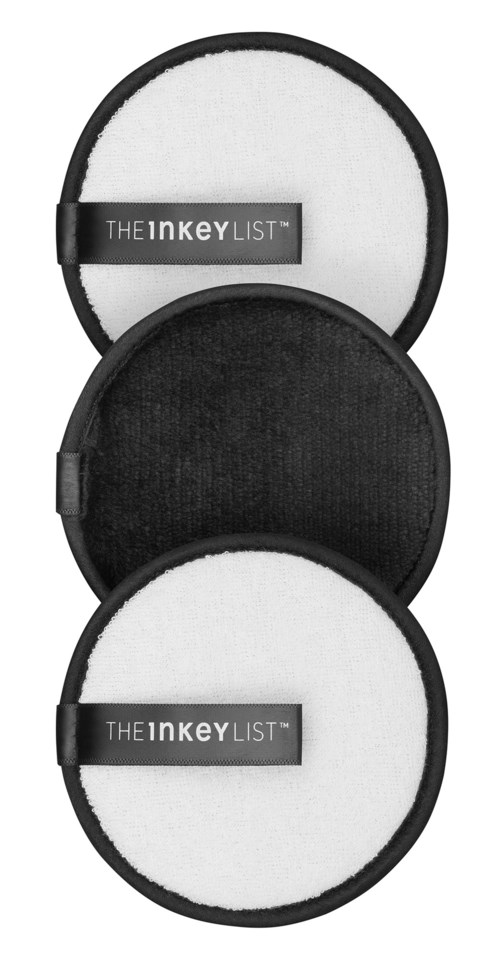 Two round black and white sound filter covers, one with a label saying 'The INKEY LIST' and the other plain.