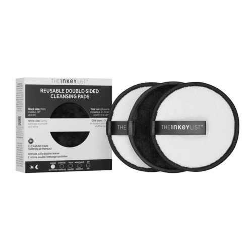 A box of black and white double-sided cleaning pads and three pads placed beside it.