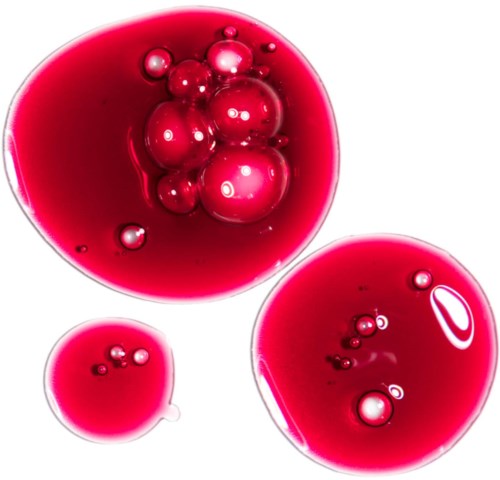 Red liquid with bubbles of different sizes, three distinct circular shapes. Looks like a close-up of oil and water mix.