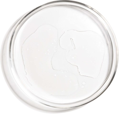 Clear liquid in a round glass container, with some cracks or bubbles on the surface.