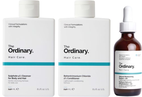 Three bottles of hair care products, including shampoo, conditioner, and treatment with dropper.