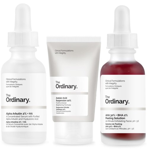 Three skincare products: a white bottle, a white tube, and a red bottle with white drops. They are from The Ordinary.