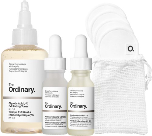 Skincare products including toner, serums, cotton pads, and a storage bag in white.