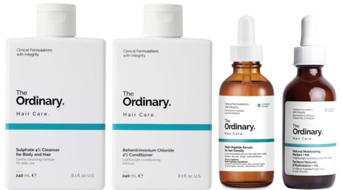 Four bottles of hair care products from The Ordinary, including cleansers, conditioner, and serums.