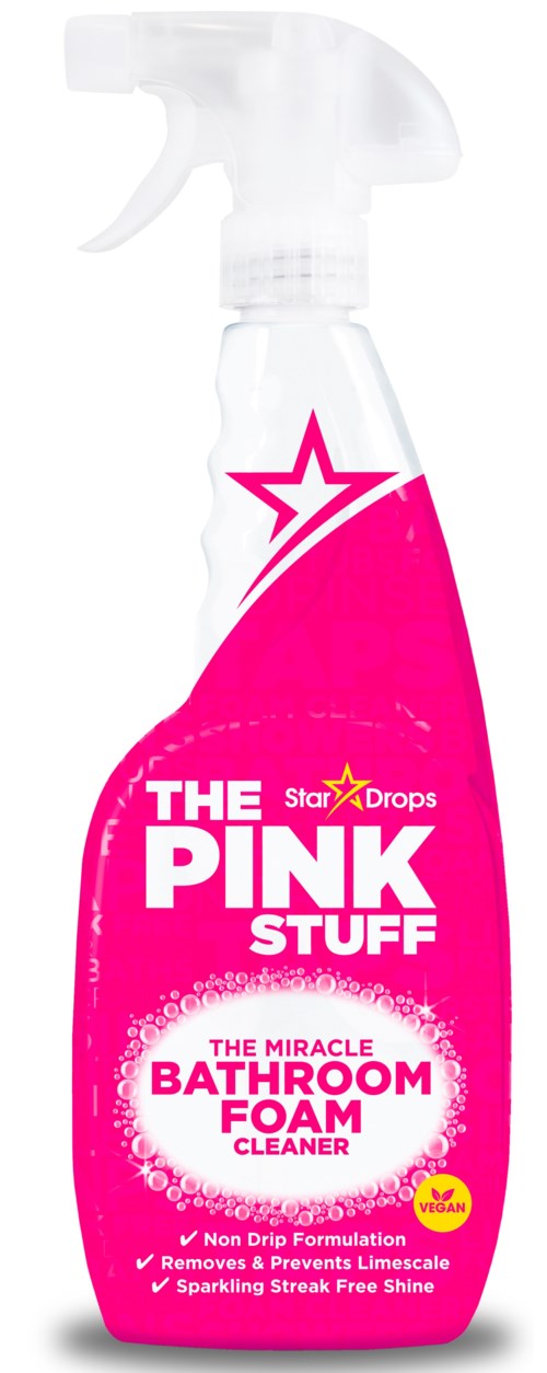 A pink spray bottle labeled 'The Pink Stuff Bathroom Foam Cleaner' with a star logo, describing cleaning features and benefits.