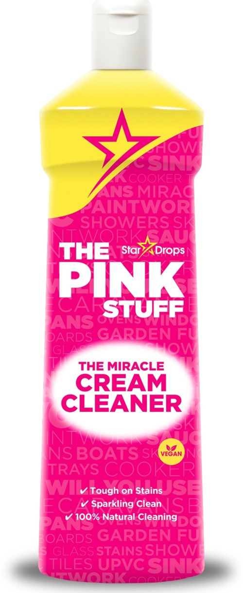 A bright yellow bottle with a pink label, showing a star and text about a cream cleaner. It mentions removing stains.