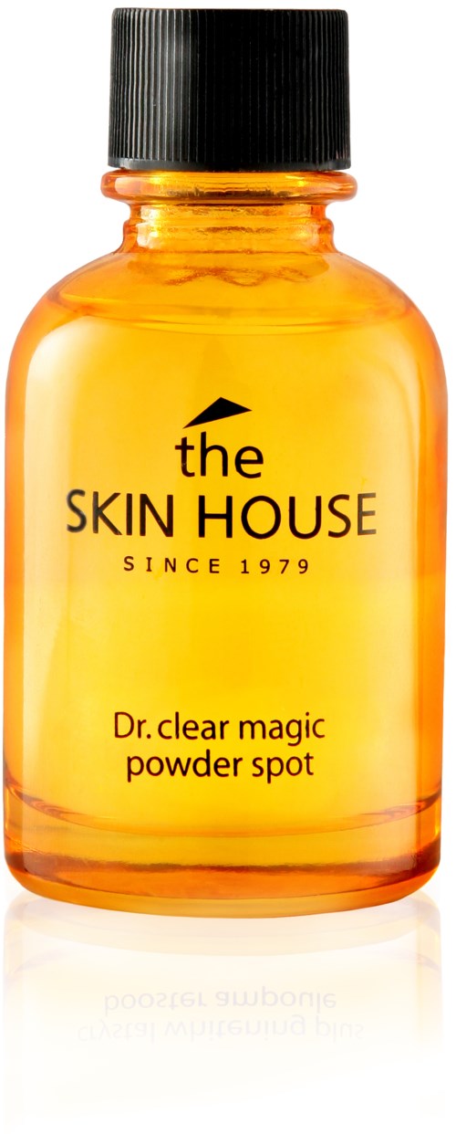 Een klein oranje fles met een zwarte dop, met een huidverzorgingsproduct genaamd Dr. clear magic powder spot.