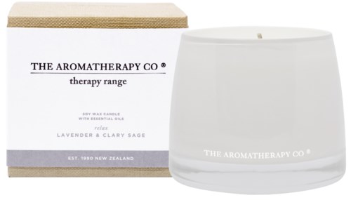 A white candle with glass holder and box label reading 'The Aromatherapy Co.' lavender and clary sage scent.