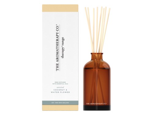 A brown bottle with sticks inside, next to a white box, labeled as aromatherapy products with coconut and water flower scents.