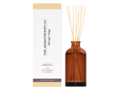 A box and a glass bottle with sticks, labeled as a reed diffuser with essential oils.