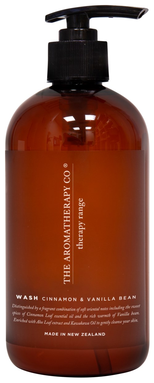 A brown bottle with a black pump and orange label, named 'Wash Cinnamon & Vanilla Bean,' made in New Zealand.