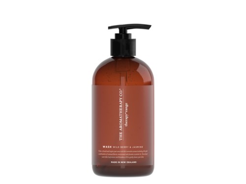 Brown bottle with black pump shows a label with white and orange text for a soap or wash product from The Aromatherapy Co.