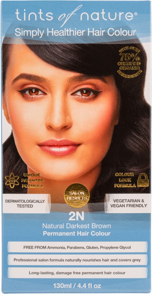 A hair dye box labeled 'tints of nature' in blue and white, showing a woman with dark brown hair. Key points: natural dark brown color, long-lasting, vegan-friendly, dermatologically tested.