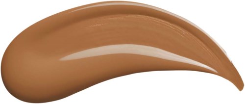 A beige and smooth, shiny substance in a curved shape, likely makeup or cosmetic product.