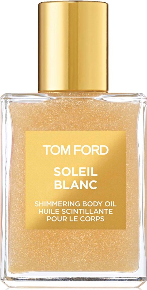 Een glazen fles met een gouden dop met glinsterende lichaamsolie. Het label leest "Tom Ford Soleil Blanc".