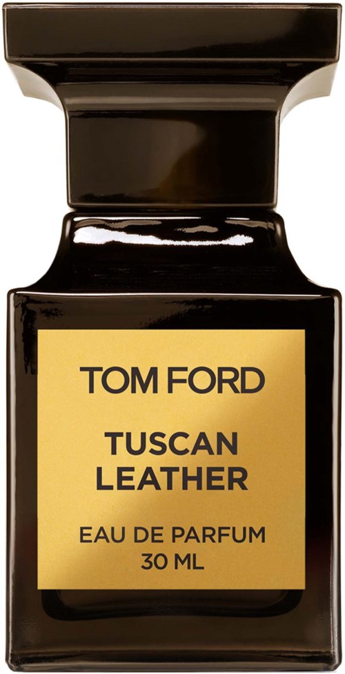A small, black perfume bottle with a gold label showing brand and scent details.