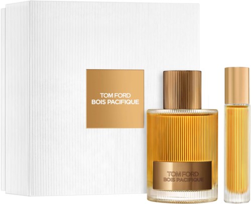 A set of Tom Ford Bois Pacificque perfume bottles with gold caps and striped yellow bottles, placed next to a white box.