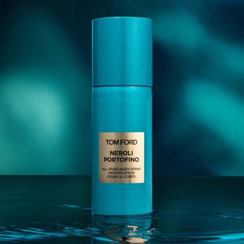 A blue cylindrical can of Tom Ford Neroli Portofino perfume with a splash of water reflection.