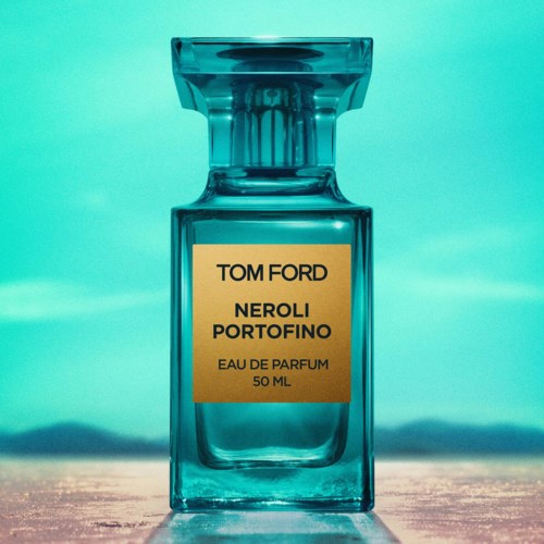A blue perfume bottle with a gold label, against a soft background. The label reads: Tom Ford Neroli Portofino, Eau de Parfum.