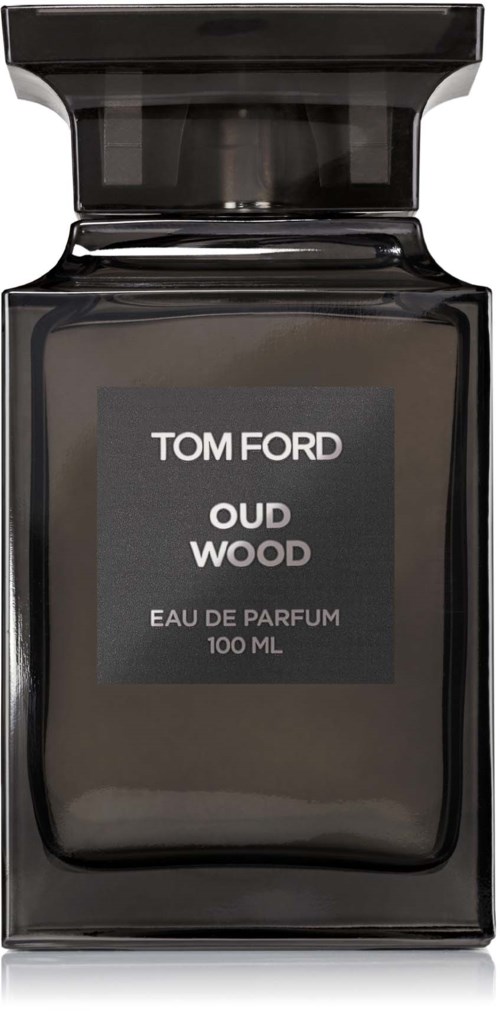 A black perfume bottle with a gray label. The label says "TOM FORD OUD WOOD EAU DE PARFUM 100 ML."