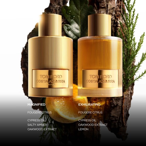 Two perfume bottles placed outdoors with natural elements like lemon, leaves, and wood background, labeled 'Magnified' and 'Exhilarating'.