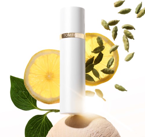A white tube beside lemon slices, green leaves, and scattered green seeds or herbs.