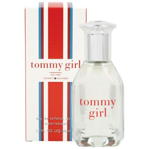 A clear perfume bottle with red text and striped packaging, labeled 'tommy girl' by Tommy Hilfiger.
