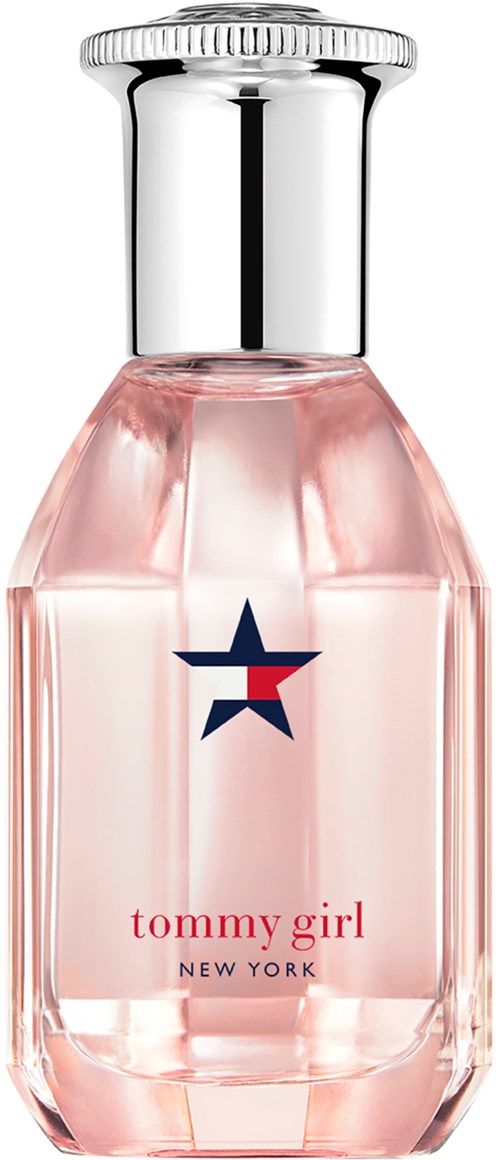 A perfume bottle with a pink liquid, a silver cap, and a star logo. The label says "tommy girl NEW YORK."