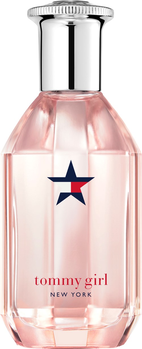 A perfume bottle with pink liquid, a silver cap, and a star logo. The label says "tommy girl NEW YORK."