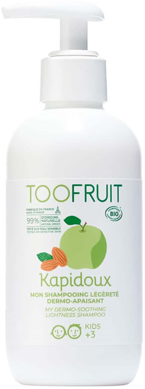 A white bottle with a pump, labeled for children's mild shampoo featuring green apple and leaves, eco-friendly and soothing.