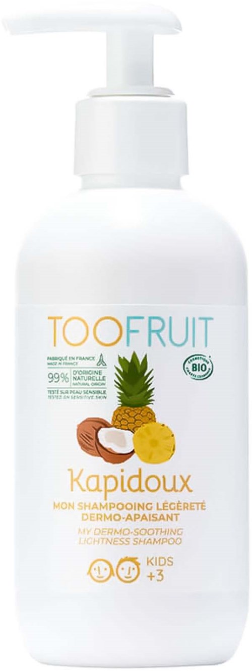 A white bottle with a pump, labeled 'TOOFruit Kapidoux', containing shampoo for kids, with pineapple and nuts illustrations.