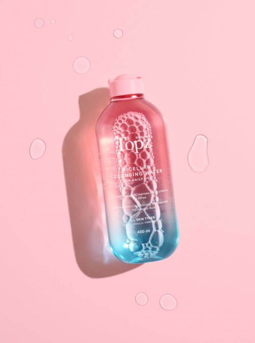 A pink and blue gradient bottle with bubbles, labeled 'Topz Cellulose Cleansing Gel' on a pink background.